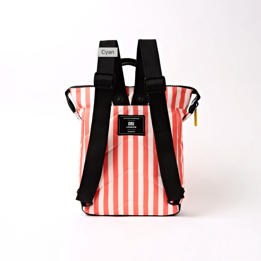 A striped tote bag with black straps, featuring vertical ORANGE and white stripes, a black front patch with 'ORU' branding, and a small tag labeled 'Cyan'.