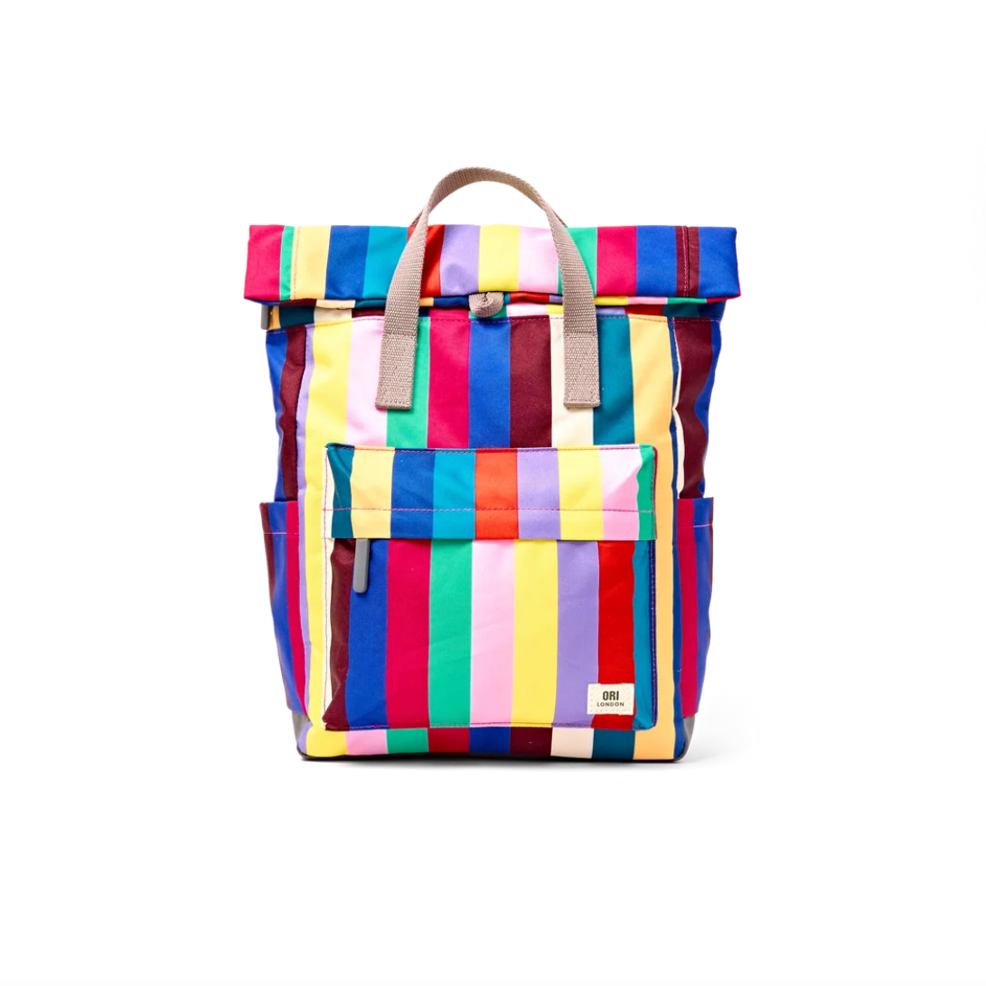 A colorful striped backpack with a roll-top closure, tan leather handles, and a front pocket, shown against a plain white background.