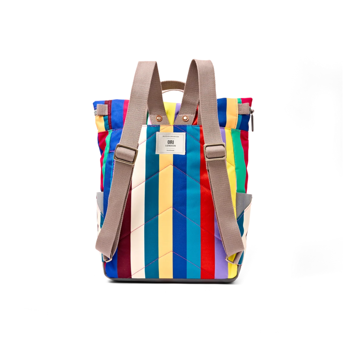 A colorful striped backpack with vertical panels in red, blue, yellow, white, and purple, featuring beige shoulder straps and a white brand label that reads 'DRI'.