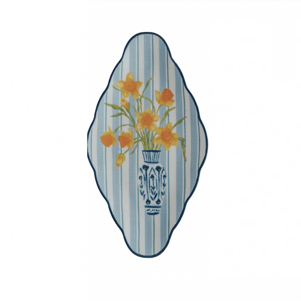 Decorate your table with our Textured Stoneware Plate featuring a charming floral design in a blue stripe vase. Made from high-quality stoneware, this plate adds texture and style to your meals. A perfect addition to your dining experience. 11"L x 6"W