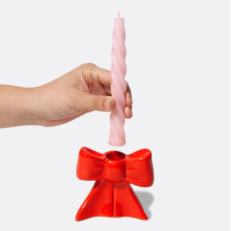 Ceramic candle holder shaped as a bow, taking inspiration from the ethereal ballet world and the whimsical allure of coquetry. 