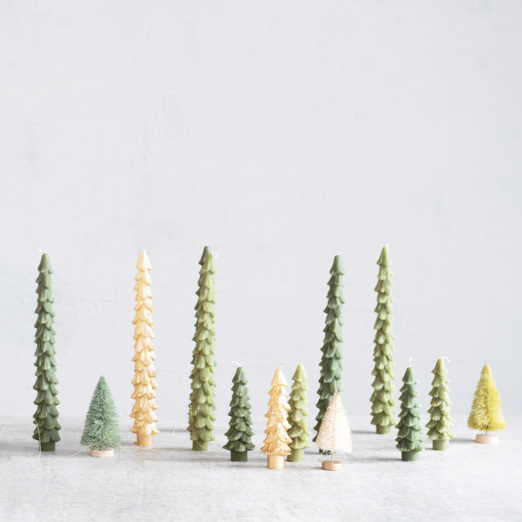 Row of small Christmas trees on a light gray background