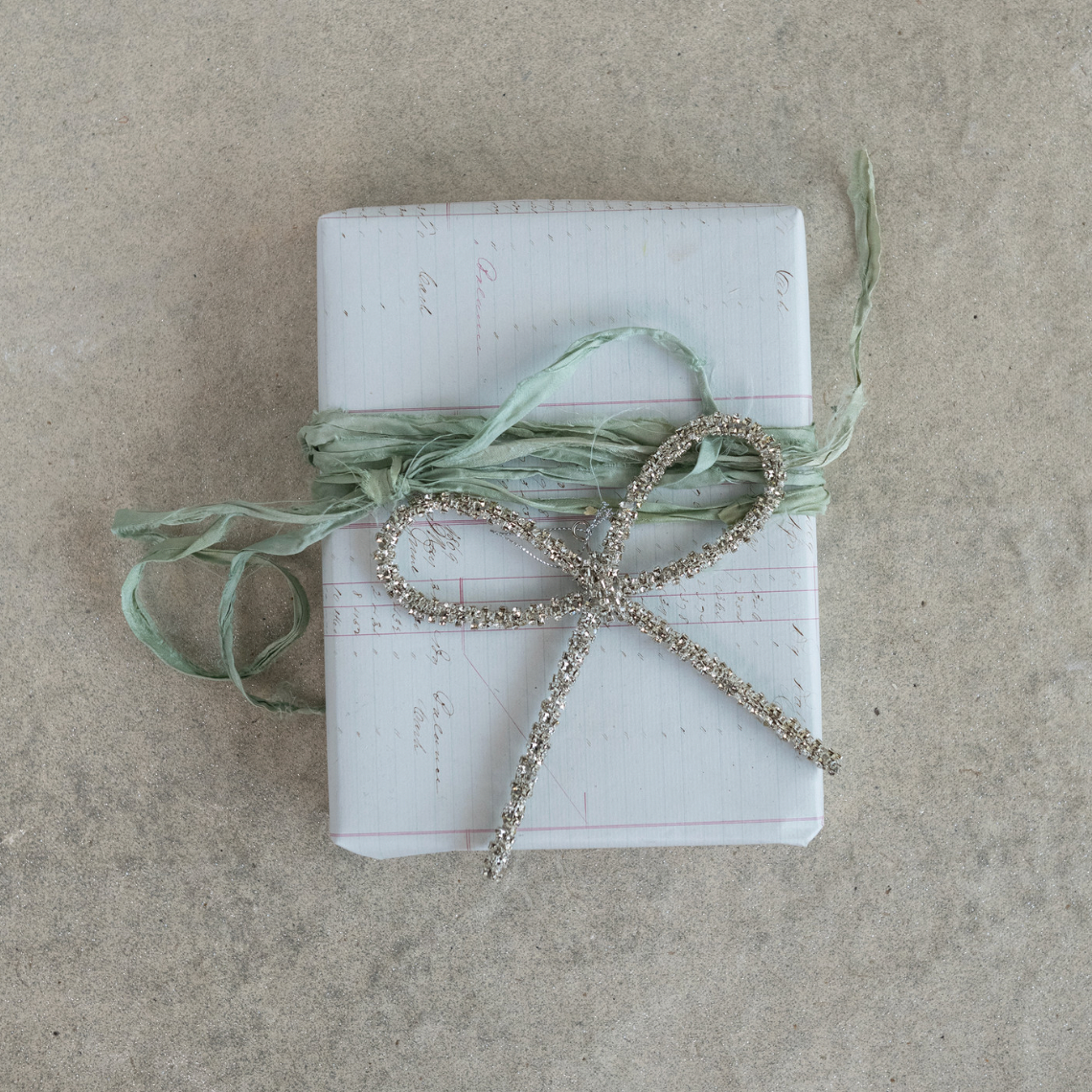 Gift wrapped with a decorative bow on a textured surface