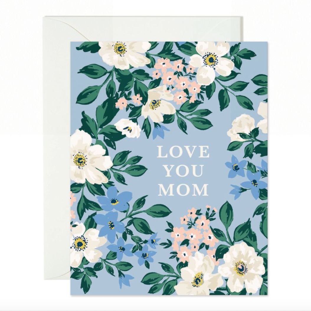 Blank notecard with white font, "LOVE YOU MOM" on a light blue background surrounded by briar roses. 