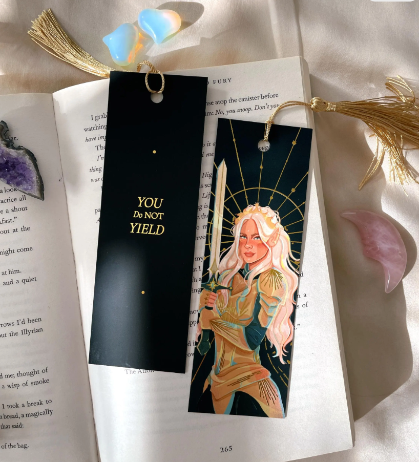 Gold foil bookmark with "you do not tield" quote on back 