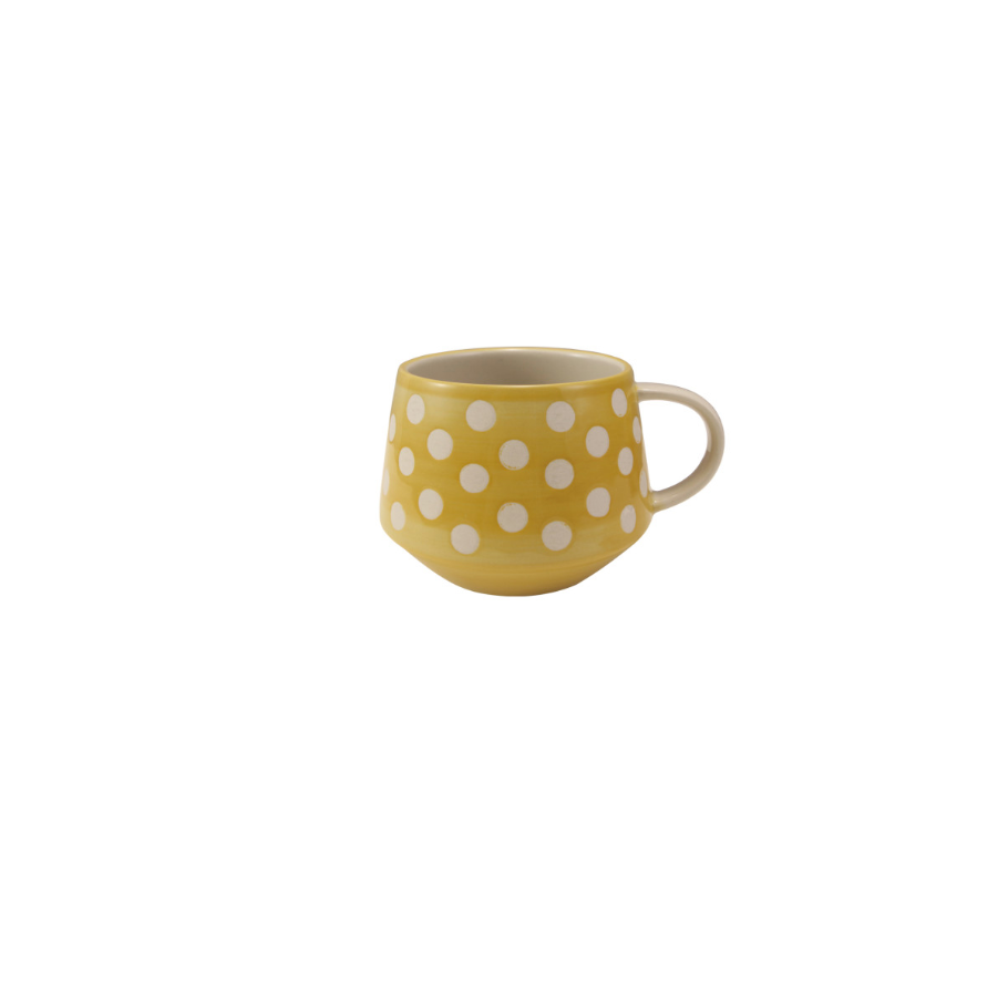Yellow mug with white polka dots on a white background