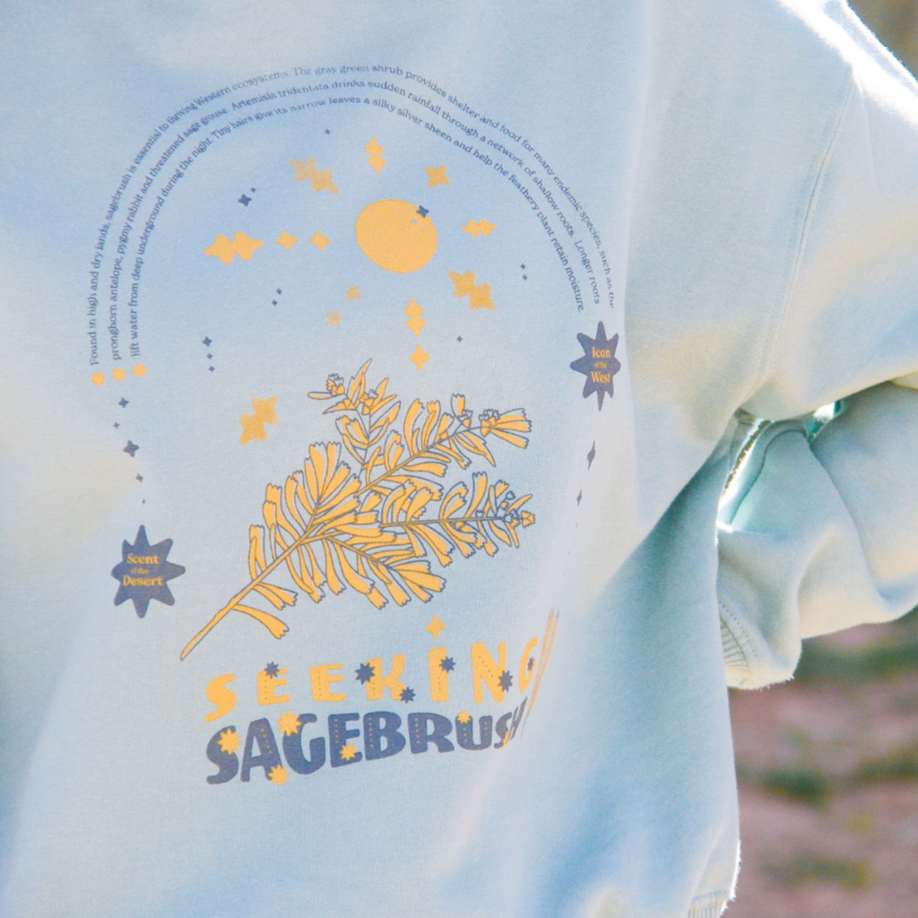 This fleece-lined sweatshirt is your new go-to for long drives and cool desert nights. Featuring drop-shoulder sleeves, ribbed-knit openings, and a boxy cut, this garment exudes casual but cute vibes. Hand-drawn graphics include facts about sagebrush, an iconic Western plant that thrives in high-desert regions.