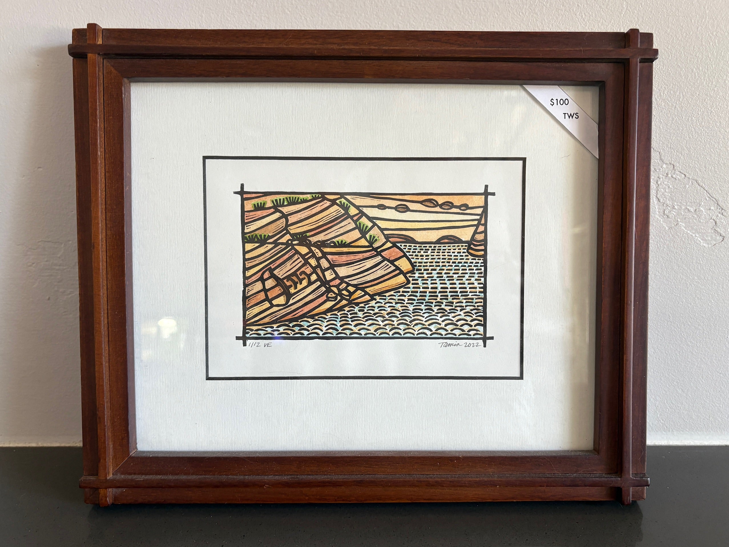 A linocut print of the landscape of Lake Powell - red rock canyons with water running through it. 