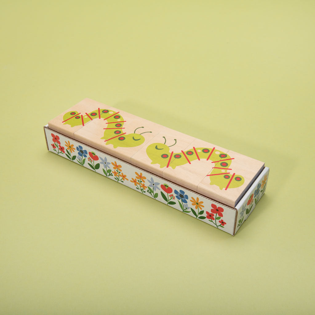 This floral frenzy is busting out with fun! Build your own garden scene. Six blocks feature tulips, colorful flowers, caterpillars, a butterfly, and more. Can you count the petals? How will you measure the inchworm with the ruler? More than colorful educational blocks, this artful set is a decorative puzzle, too. It’s blooming beautiful!  6 - 3 x 1.75 inch blocks
