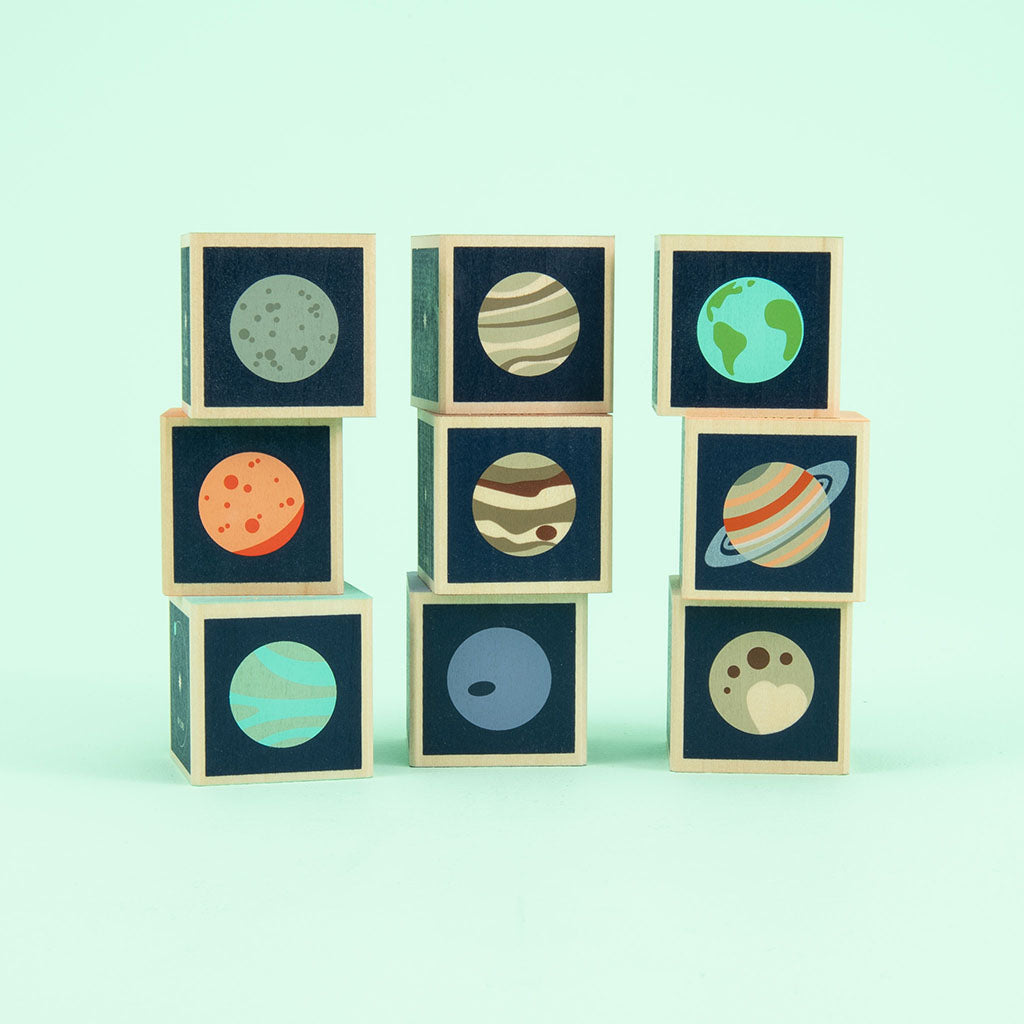 Mercury. Venus. Earth. Mars. Jupiter. Saturn. Uranus. Two debossed sides feature the planet’s symbol, name, and number of moons. The four printed sides reveal a planet illustration, diameter, location, and distance from the sun. This 9 block set honors all 8 planets in our solar system; plus a bonus dwarf planet, Pluto.