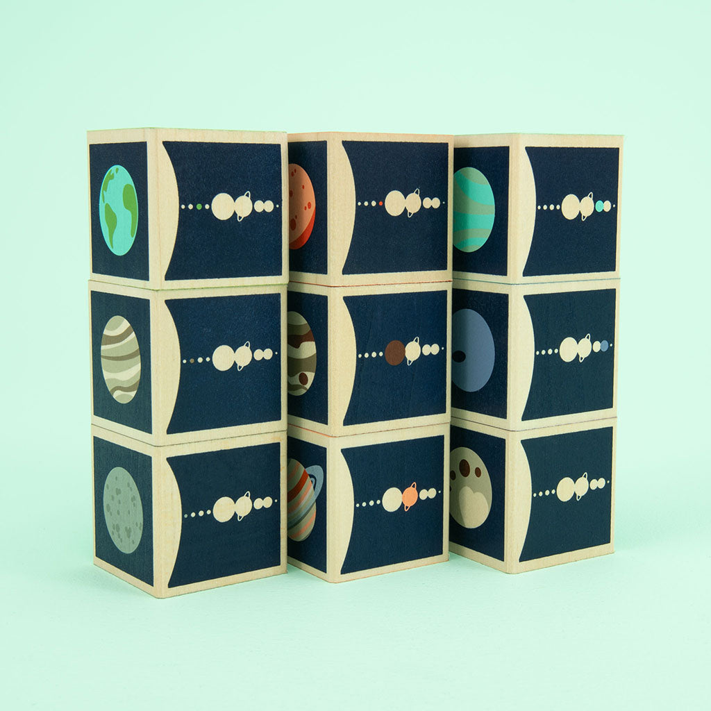 Mercury. Venus. Earth. Mars. Jupiter. Saturn. Uranus. Two debossed sides feature the planet’s symbol, name, and number of moons. The four printed sides reveal a planet illustration, diameter, location, and distance from the sun. This 9 block set honors all 8 planets in our solar system; plus a bonus dwarf planet, Pluto.