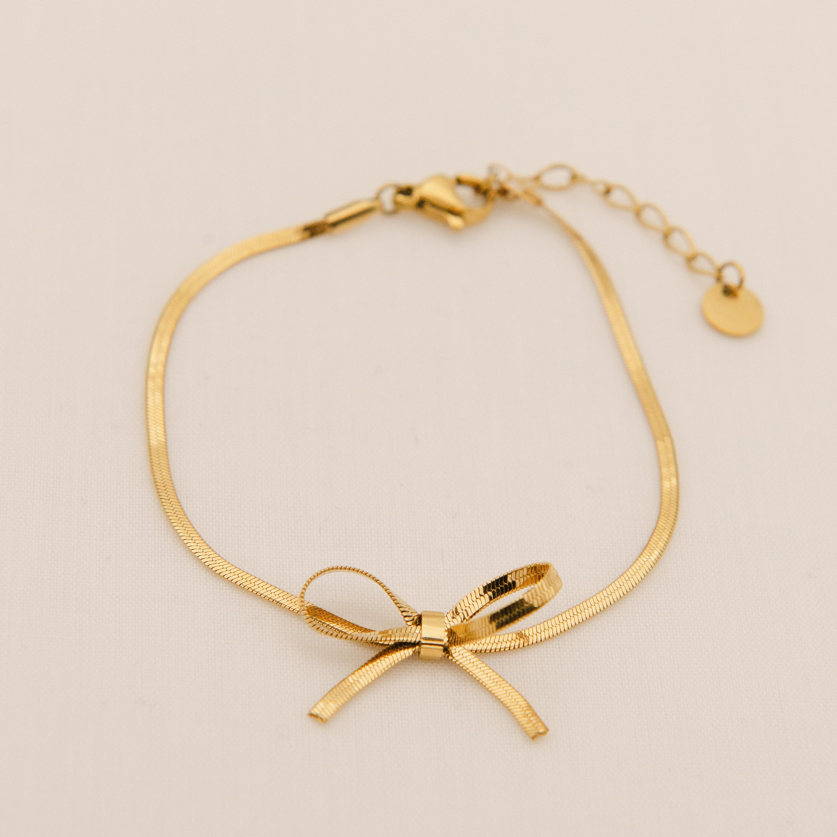 gold snake chain bracelet with simple  tied bow, including extender.