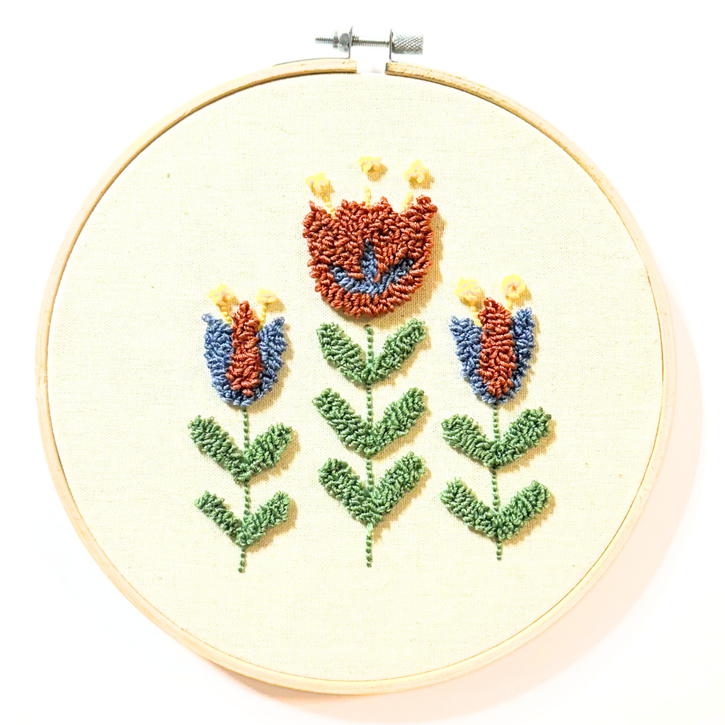 3 rust and blue colored nordic flowers