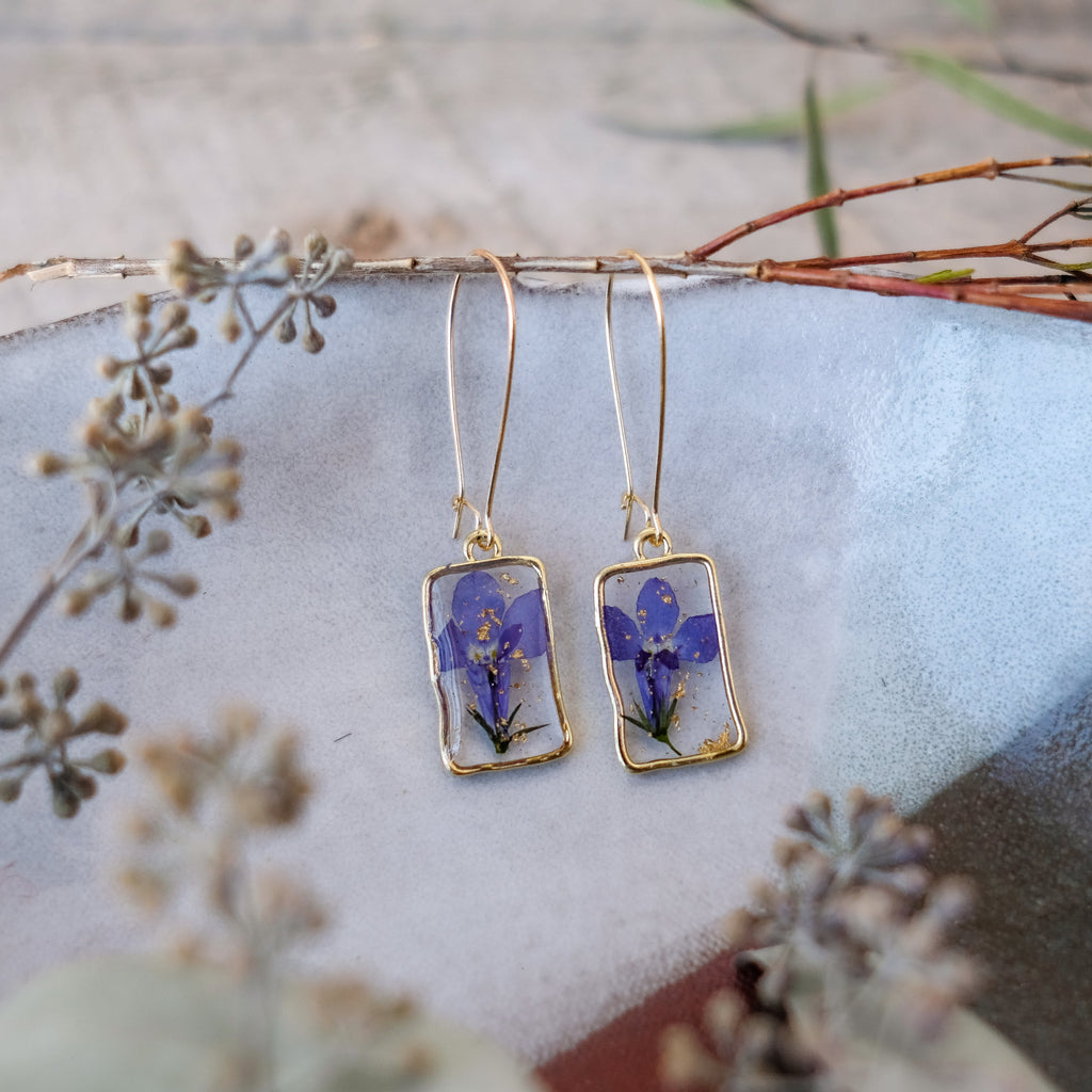 blue violet pressed flowers in gold rectangle bezels on hoops