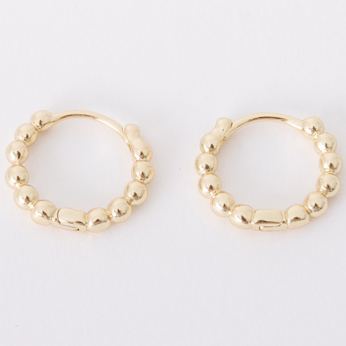 With a light and fun design, these bubble huggies have everything you love about huggies mixed with a new, playful style that makes them essential all day wear. These earrings go with EV. ERY. THING.  They are both timeless and on trend.  Their unique click in click out clasp allows you to leave them in day and night without any discomfort. 