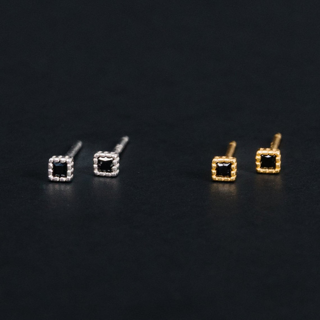 We love a huge burst of color as much as the next person, but sometimes we just gotta embrace our dark side.  These earrings are all about the moody, dark, cozy vibes.  The black shine, all day comfortable wearing, and ability to leave in for weeks at a time make these dark mode earrings a no brainer.  These screwbacks are here and ready to carry us into the next season of our lives! Black crystal square studs.