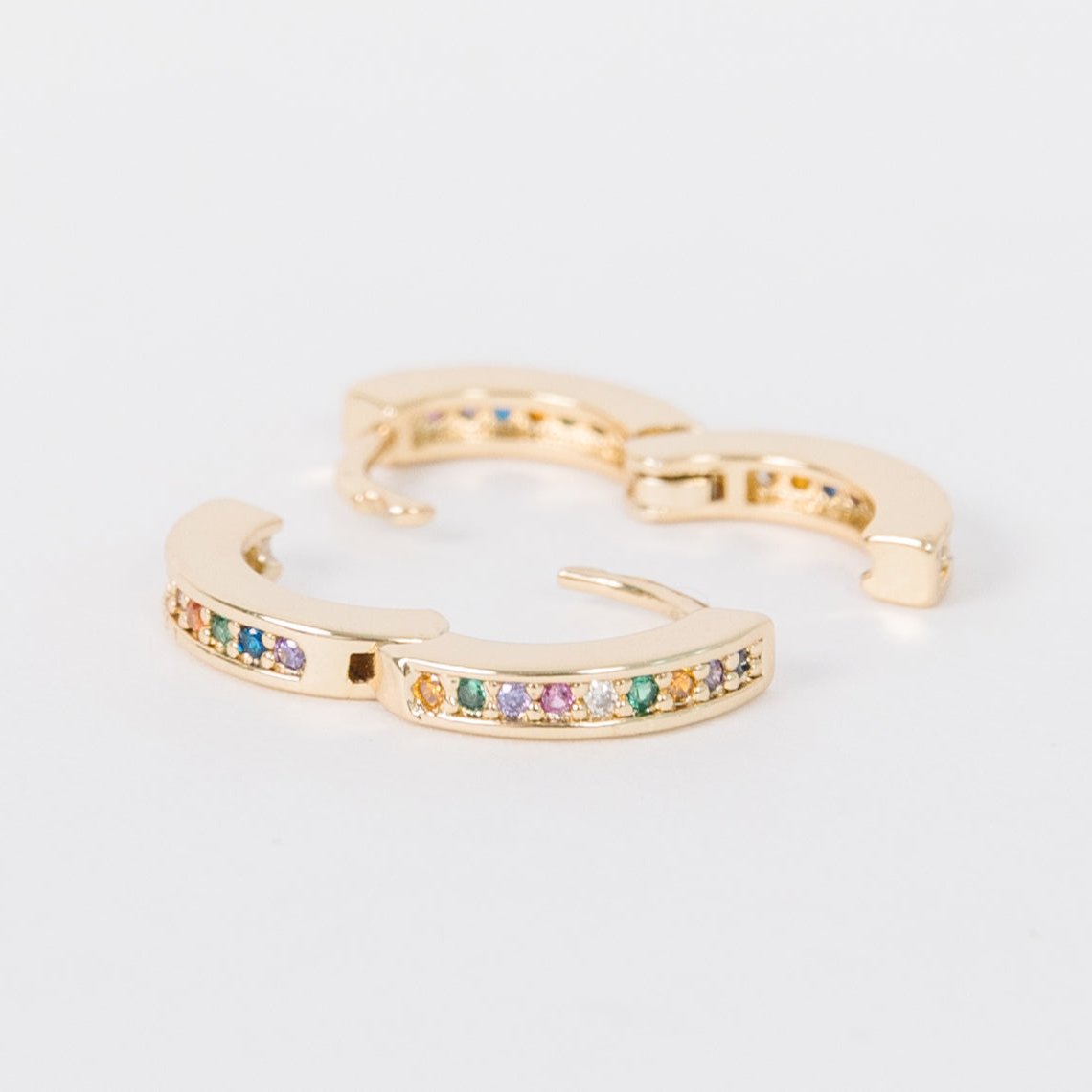 14k Gold Filled 12 mm huggie clasp Safe for sensitive skin Unique clasp has no post when earrings are closed, allowing for comfortable wear and sleep without having to remove earrings Multicolored bejeweld stones&nbsp;are 2 mm Perfect for mulitple piercings Freaking cute and freaking tiny