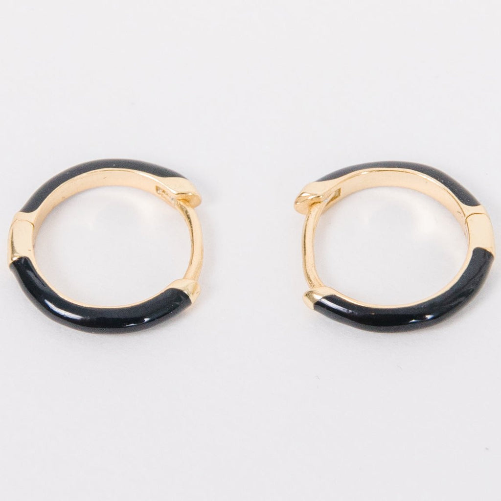 These ultra thin huggies capture all we love about moody fall in the slimmest most subtle way.&nbsp; The black enamel, effortless click in click out, and ability to leave in for weeks at a time make these dark mode earrings a no brainer.
