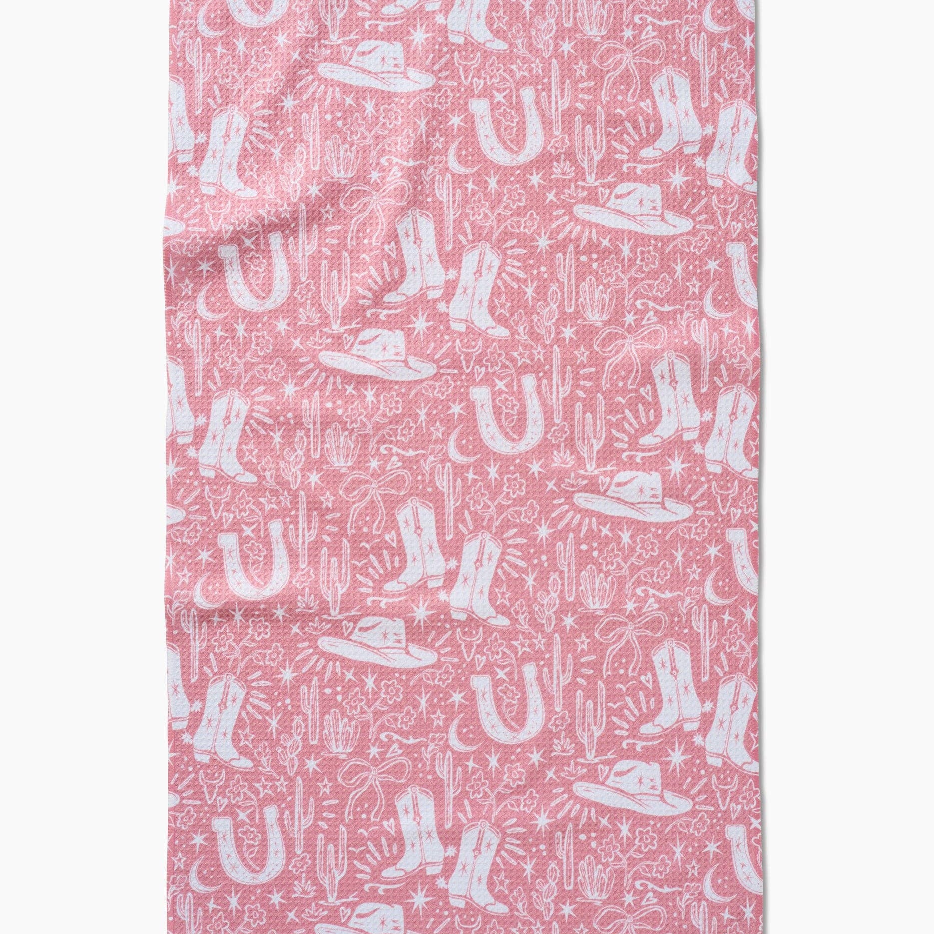 Pink towel with white cowboy boot and hat pattern on a white background