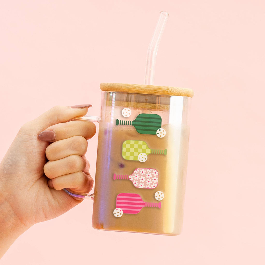 Enjoy your favorite drinks in style with our 20 oz square glass cups. With their beautiful iridescent glass and sleek square shape, these cups are perfect for everything from iced coffee to seasonal cocktails. The bamboo lid and glass straw make it easy to take your beverage on-the-go while adding a touch of elegance to your day.

Details:

Beautiful, iridescent glass
Square shape with a perfectly crafted handle
Bamboo lid and glass straw included
Design printed directly on the glass
Hand wash recommended