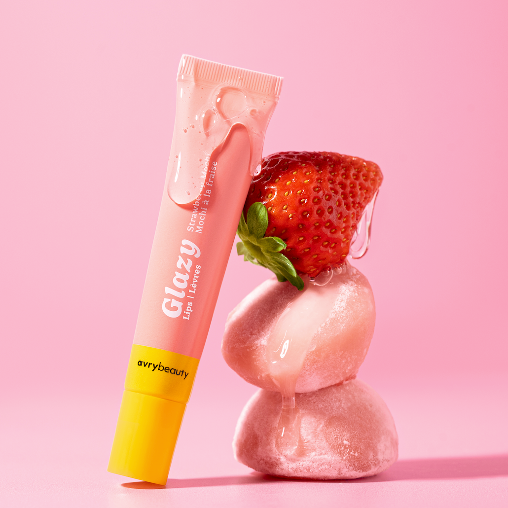 Tube of Glazy lip balm with a strawberry on a pink background