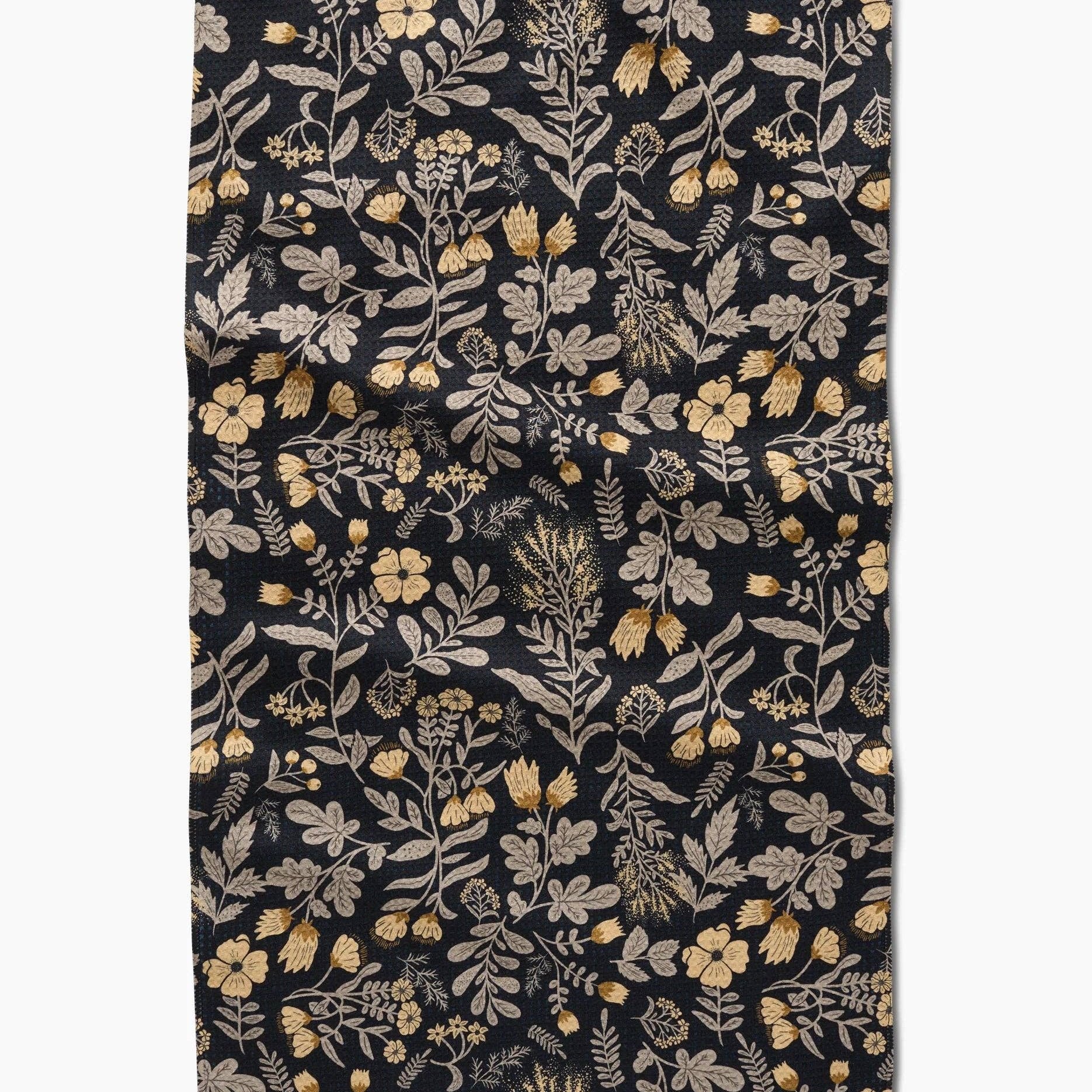black tea towel with yellow/green floral pattern