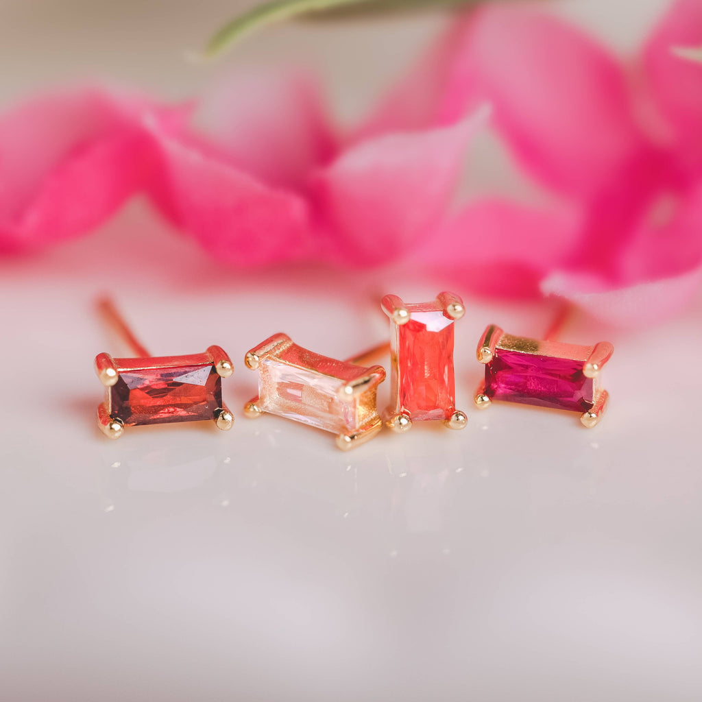  Birthstone Ombre Baguette Stud Earring Set, a collection of four stunning earrings crafted in 18k gold plated with an anti-tarnish coating. This set of stud earrings showcases the ombre effect, seamlessly blending hues from light to dark, creating a captivating visual representation of your birthstone's color spectrum. 
