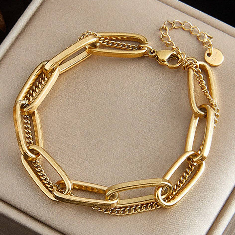 Elevate your everyday style with this beautiful 18K gold plated stainless steel layered chain bracelet—a piece designed to be as dependable as it is stunning. Crafted with care, this bracelet is hypoallergenic, waterproof, and tarnish-resistant, making it perfect for daily wear. Whether you're heading to the office, the gym, or out for an adventure, it moves with you without worry. To keep your bracelet looking radiant, we recommend avoiding prolonged contact with lotions, perfumes, and cleaning products.