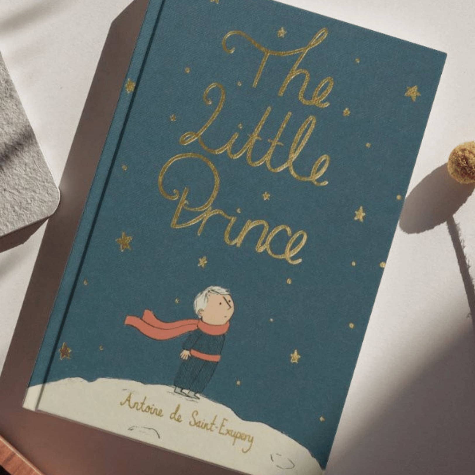 Book titled 'The Little Prince' on a white surface