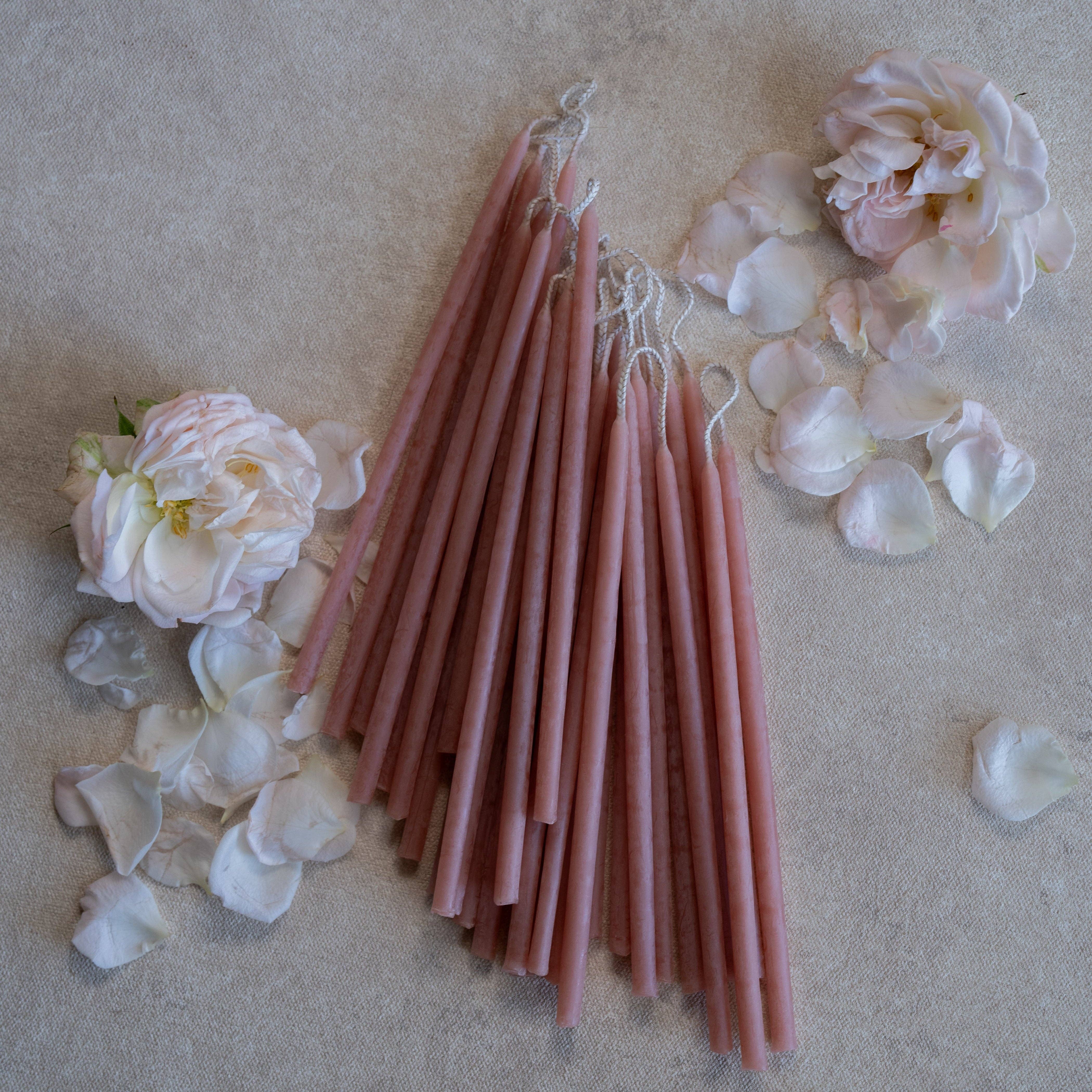 blossom Pink candles with floral decorations on a textured surface