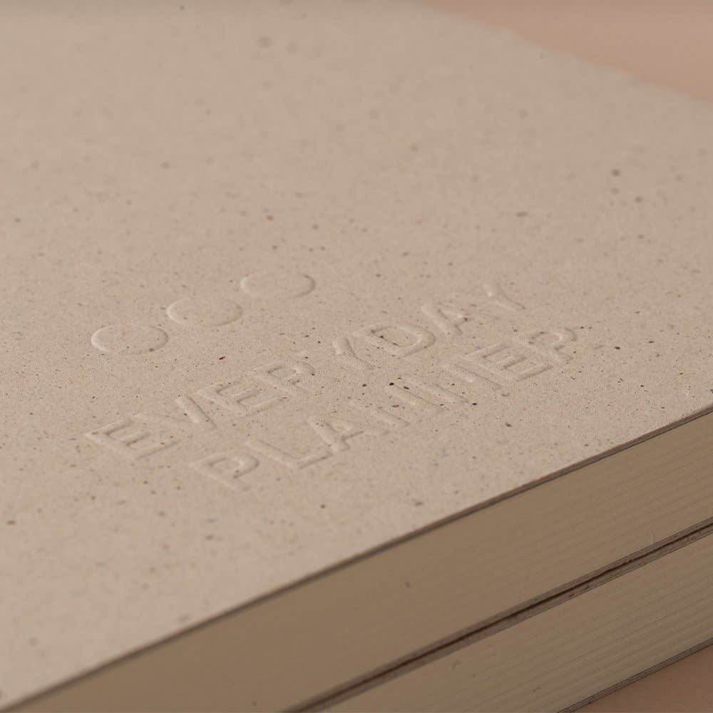 Close-up of a beige surface with embossed text 'Coco Elements Plankies'.
