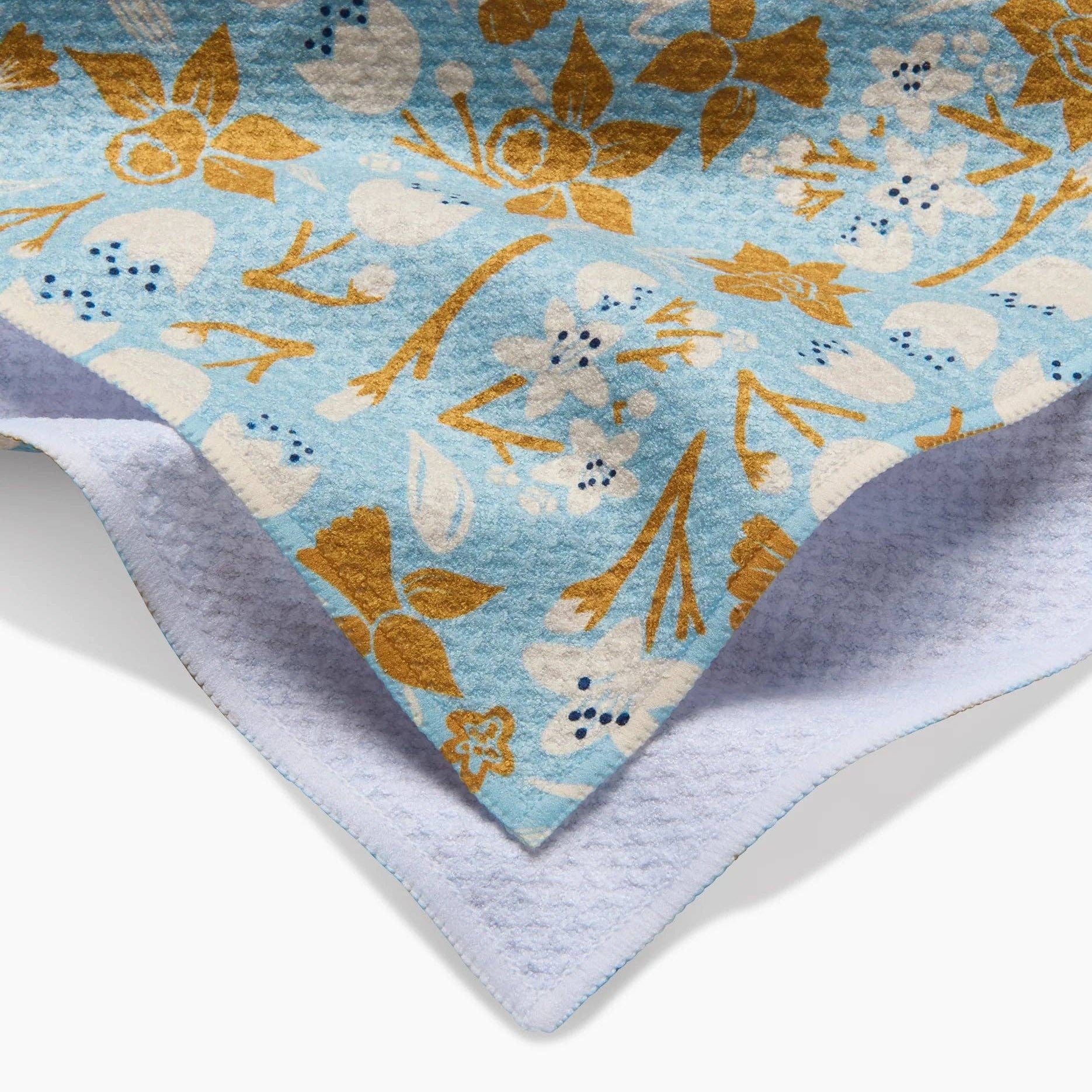 Floral patterned fabric with a soft texture on a white background Tea Towel