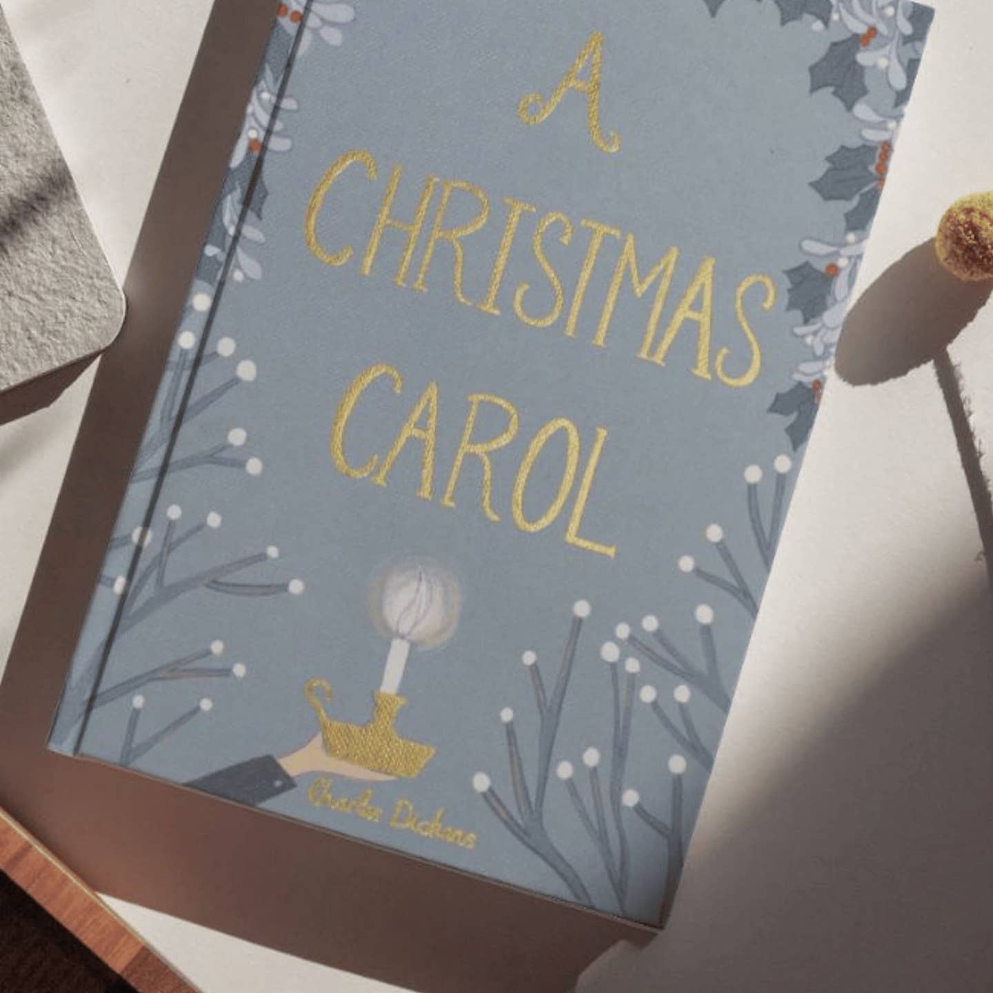 Book cover of 'A Christmas Carol' with decorative elements on a light background
