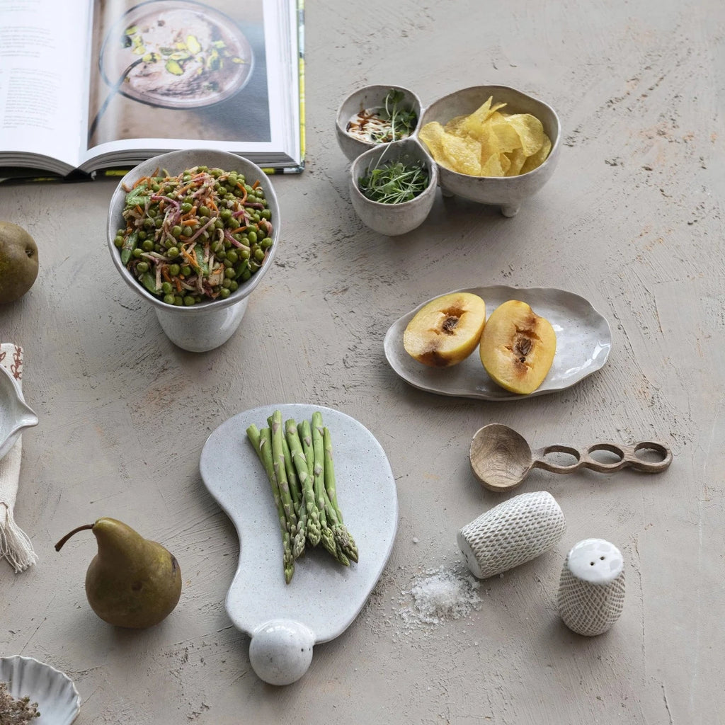 The tray is made of high-quality and durable stoneware that is easy to clean and care for. This stoneware tray with ball and reactive glaze in cream is an excellent choice for self-care or special occasions.