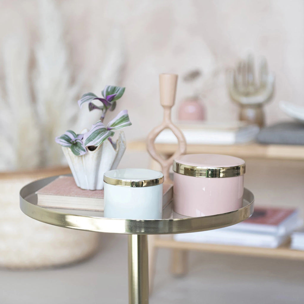 This pink enameled metal box with gold interior is a beautiful and classy piece that can add some charm to any space. The box features a round metal shape with a pink enameled coating that gives it a smooth and glossy look. The interior of the box has a gold finish that adds a touch of luxury and glamour.