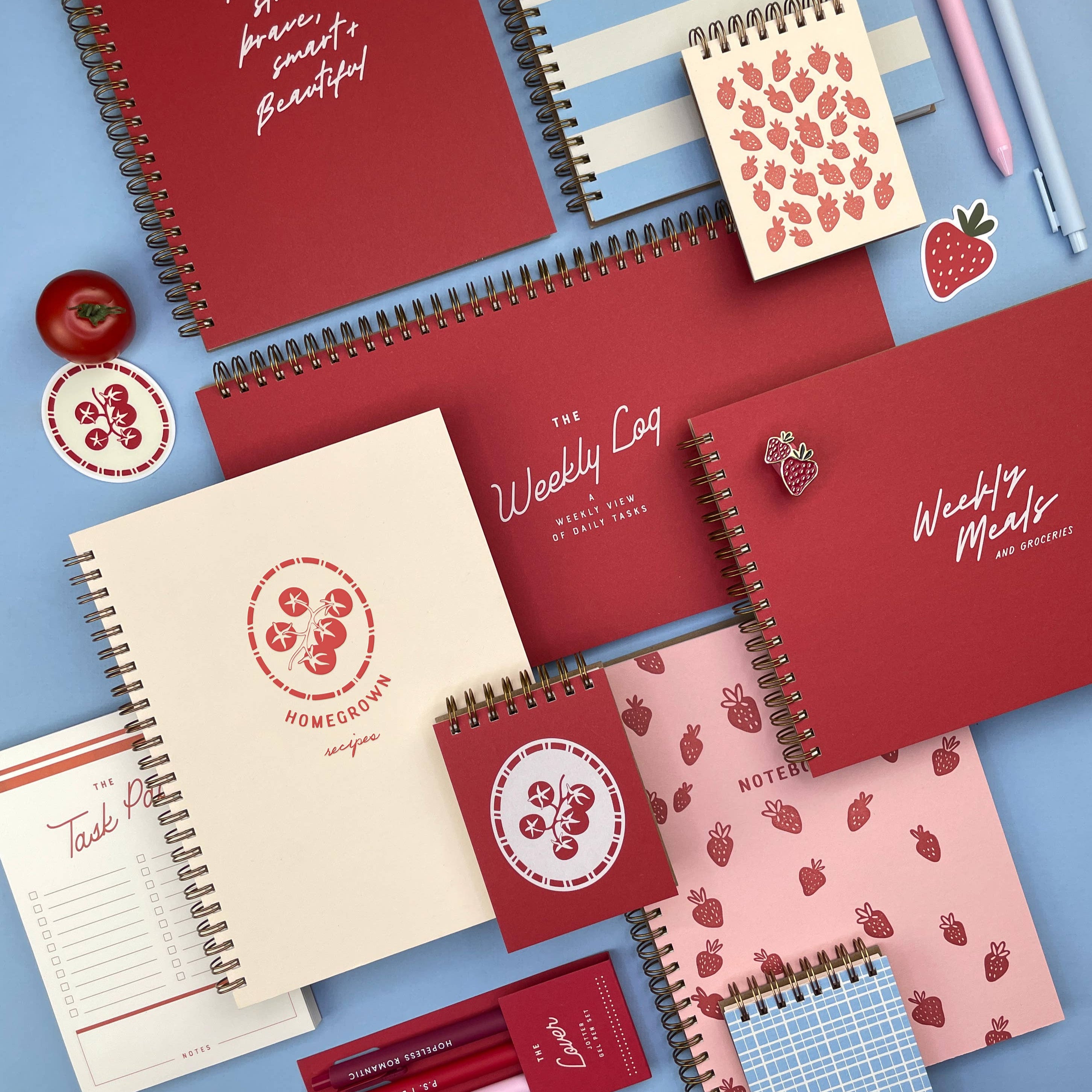 Collection of red notebooks with various designs on a blue background