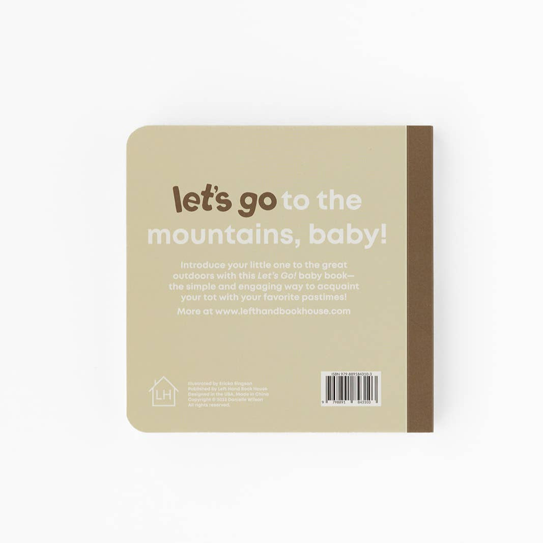 Beige notebook with text 'let's go to the mountains, baby!' on a white background