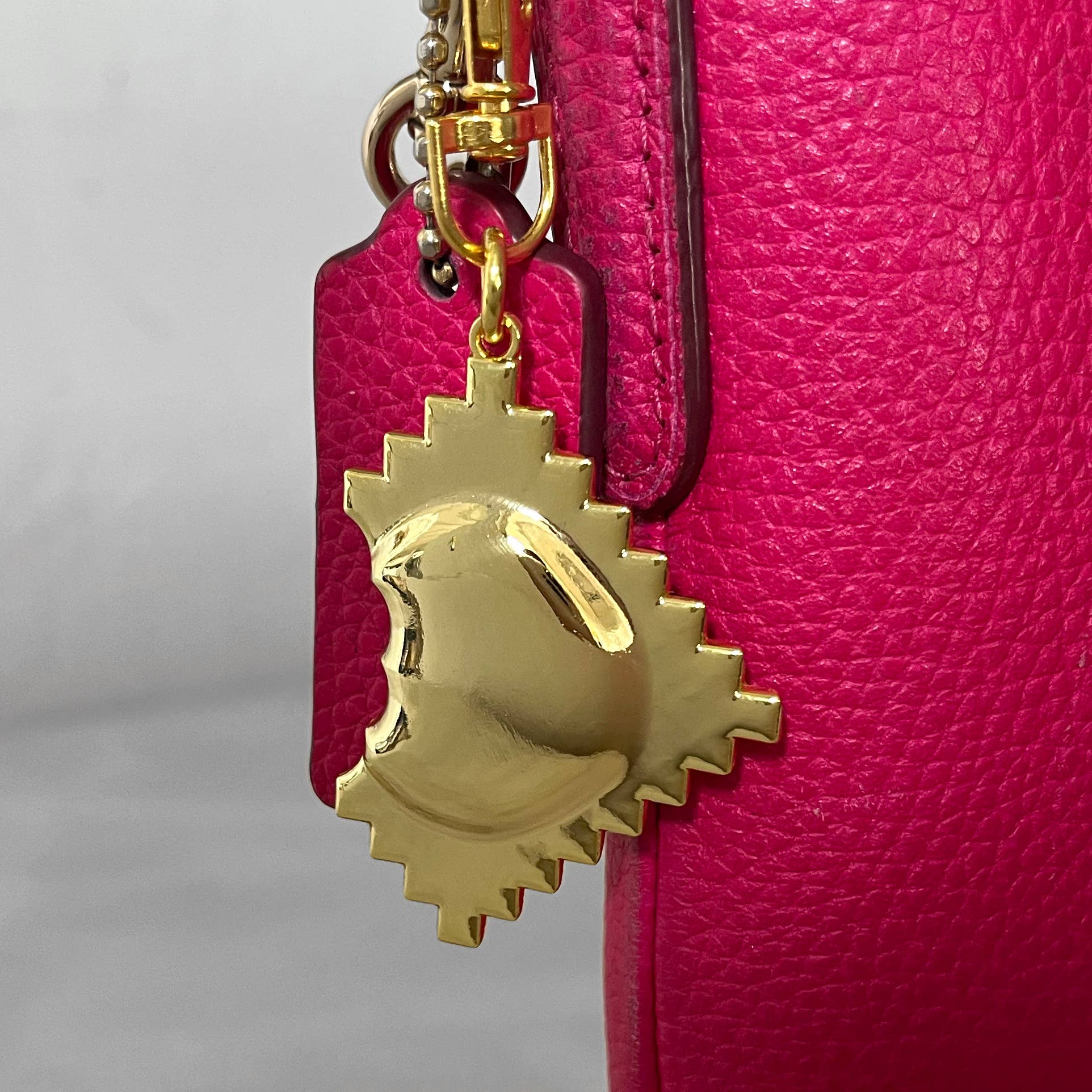 I designed this golden charm to look like a 3-D ravioli with a bite taken out of it. Buon appetito!

Details:

3-D charm
1 &amp; 7/8 x 1 &amp; 7/8 inches (36 x36 mm)
Gold tone metal
Comes with clip and keyring, mounted on display card