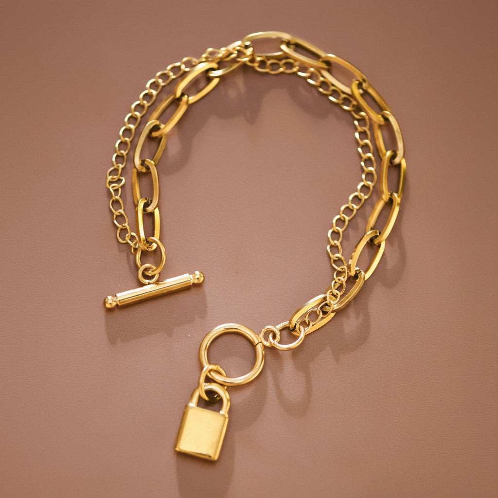 Elevate your everyday style with this 18K gold plated stainless steel chain link bracelet. Featuring a sleek lock charm, layering chains and hypoallergenic construction, it's perfect for sensitive skin. The waterproof and tarnish-resistant design withstands daily wear, sweat, and moisture—ideal for active lifestyles. To maintain its lustrous finish, avoid prolonged contact with lotions, perfumes, and cleaning products. A timeless piece that transitions seamlessly from casual to elegant occasions.