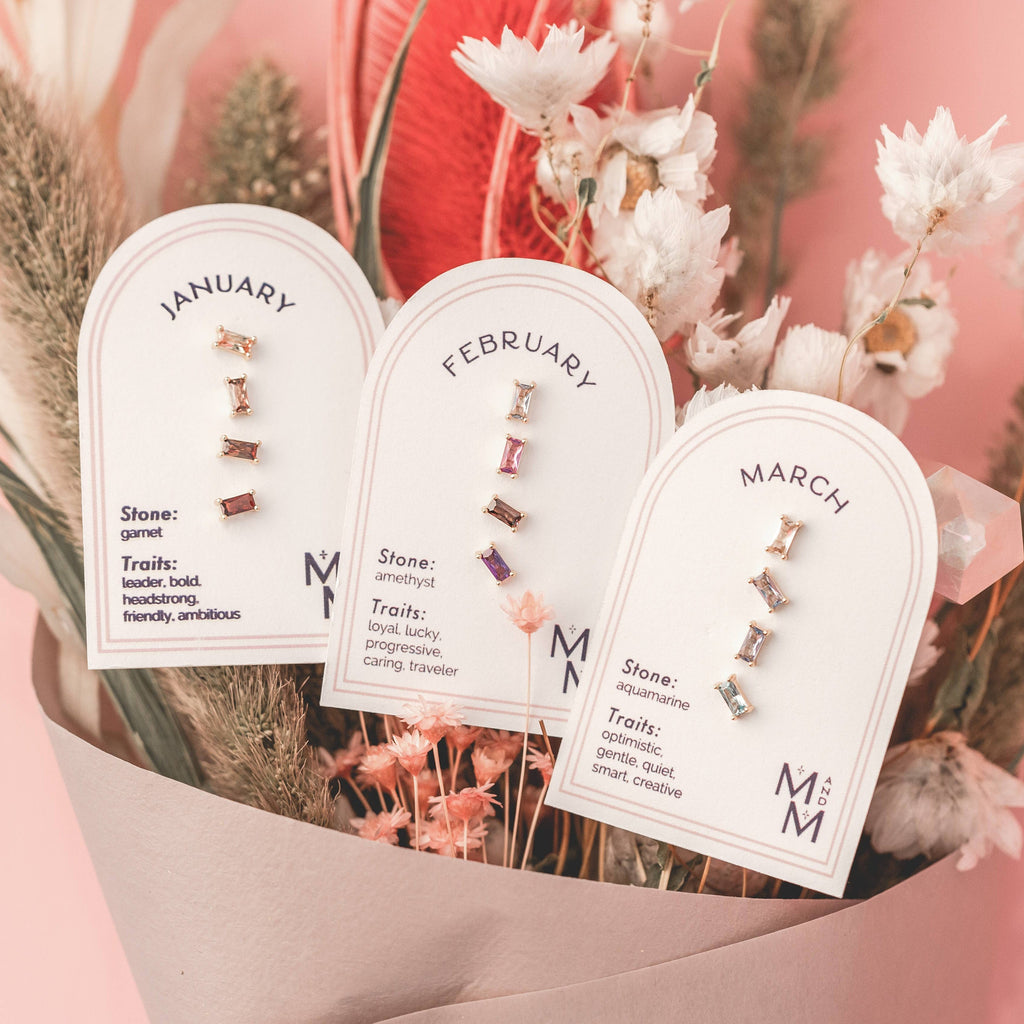  Birthstone Ombre Baguette Stud Earring Set, a collection of four stunning earrings crafted in 18k gold plated with an anti-tarnish coating. This set of stud earrings showcases the ombre effect, seamlessly blending hues from light to dark, creating a captivating visual representation of your birthstone's color spectrum. 