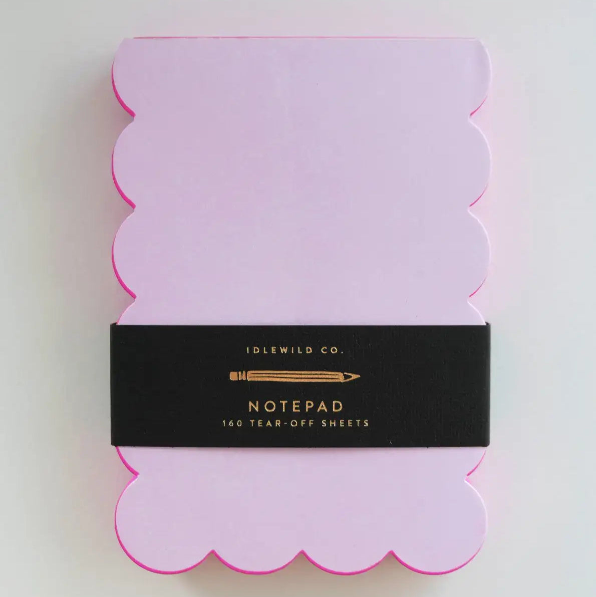 Pink scalloped notepad with black label on a white background