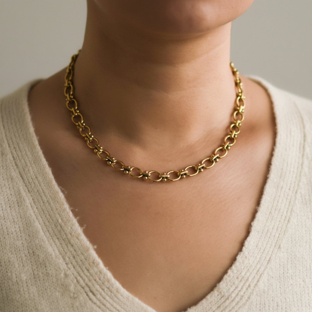 18K Gold Dipped Stainless Steel Oval Chain Necklace Elevate your everyday style with this timeless oval chain necklace, crafted from hypoallergenic stainless steel and finished with 18K gold plating. Measuring approximately 18 inches with an adjustable extender, it offers the perfect fit for any neckline. Designed for durability, this necklace is waterproof and tarnish-resistant, making it ideal for daily wear. The gold-plated finish maintains its lustrous shine when kept away from lotions and products.