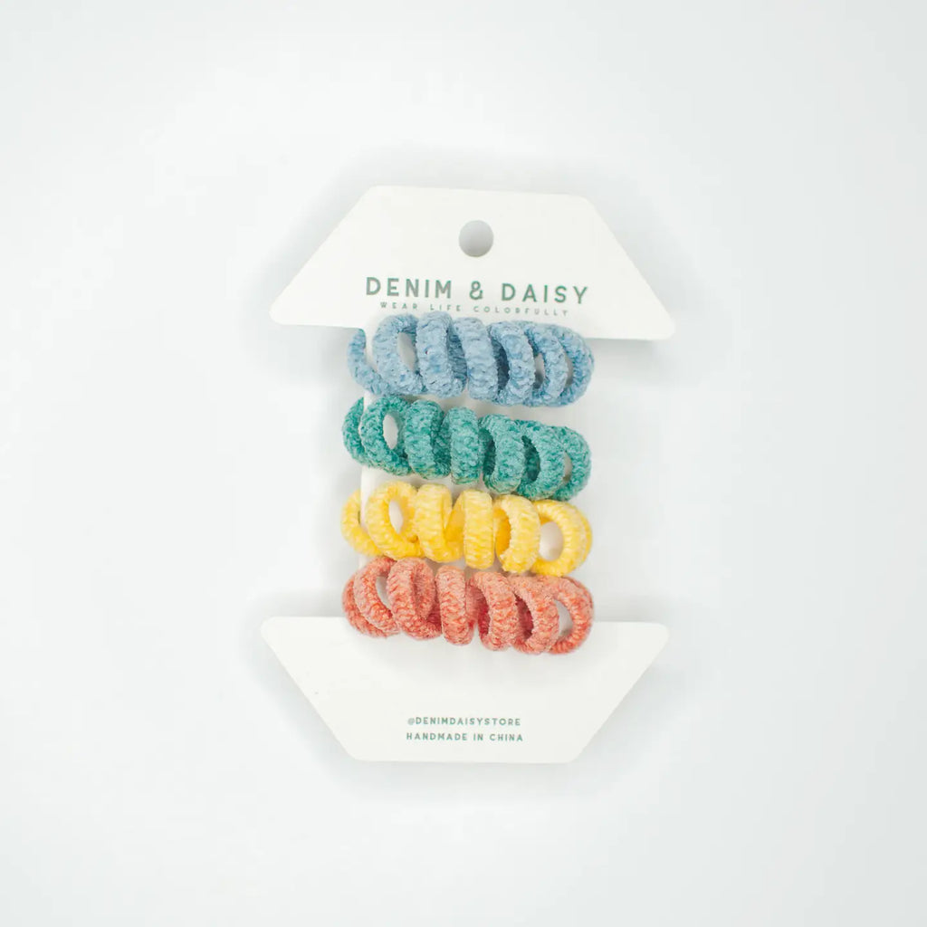 Have you seen our super cute Curly Cords? These knitted hair ties are a lifesaver for anyone who's tired of dealing with hair breakage from regular hair ties. You get four in a pack, with two different color combos. They're not only practical, but they add a bit of fun to any hairstyle. Trust me, you won't want to return to boring old hair ties once you've tried these out