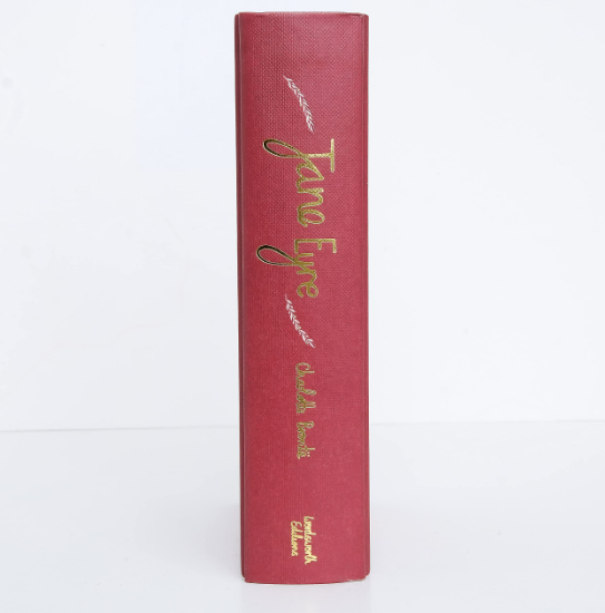 Red book with gold text on a white background
