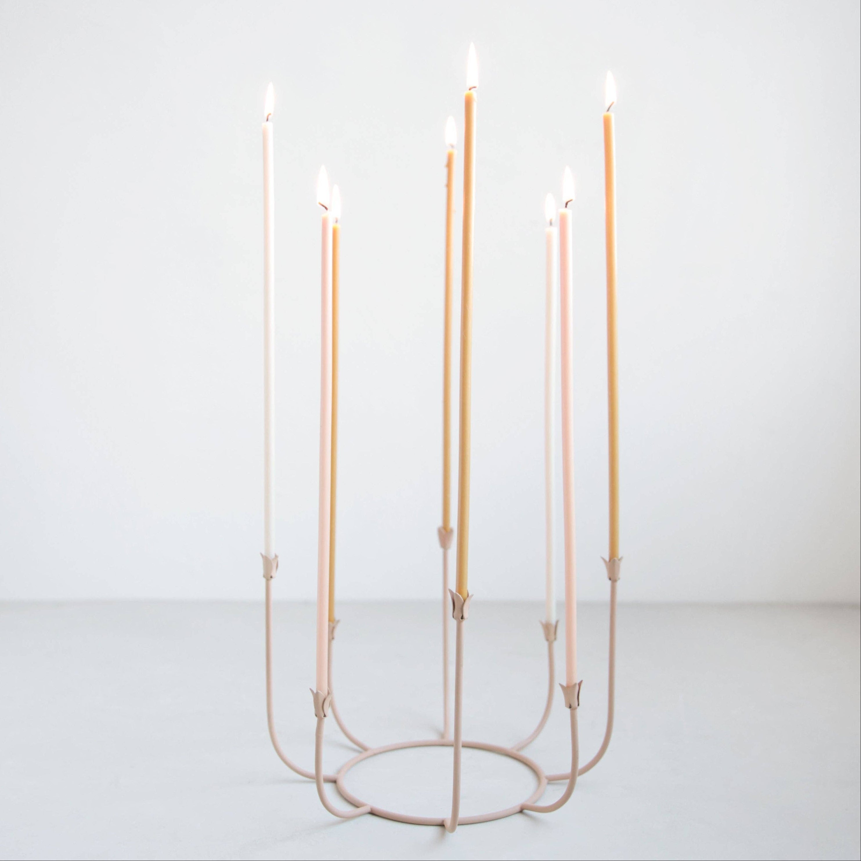 Candle holder with six candles on a white background