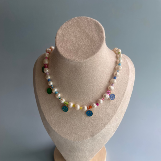 pearl necklace with blue smiley face charms and rainbow beads