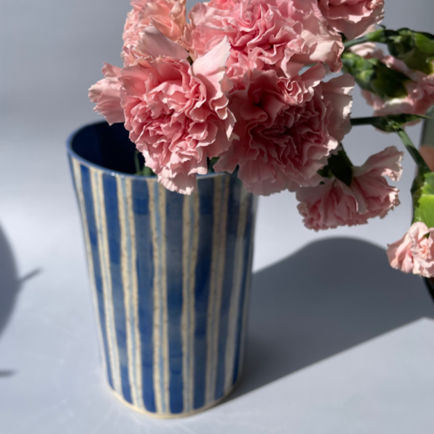 blue striped vase with pink flowers