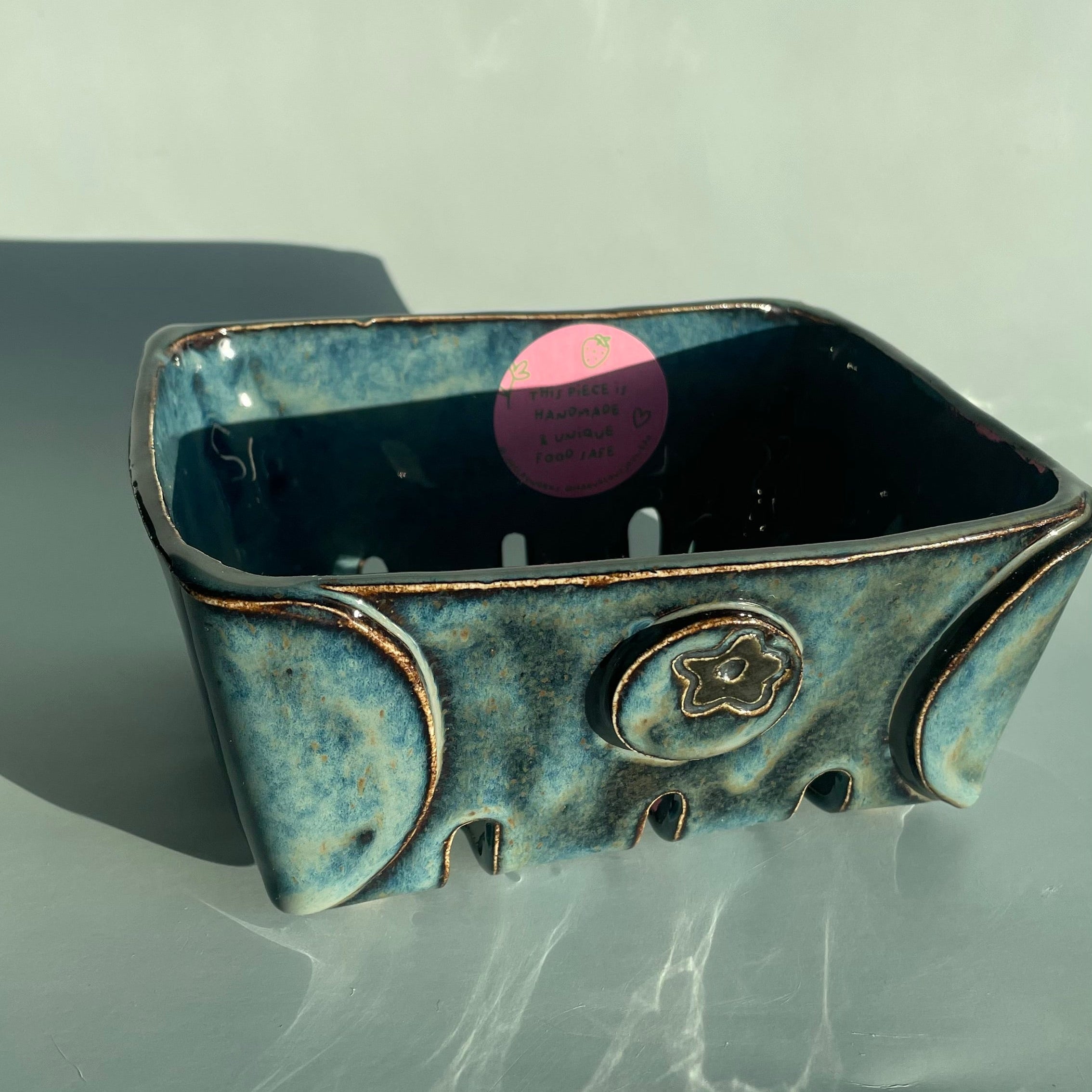 handmade ceramic blue glazed berry basket with a blueberry detail on the side