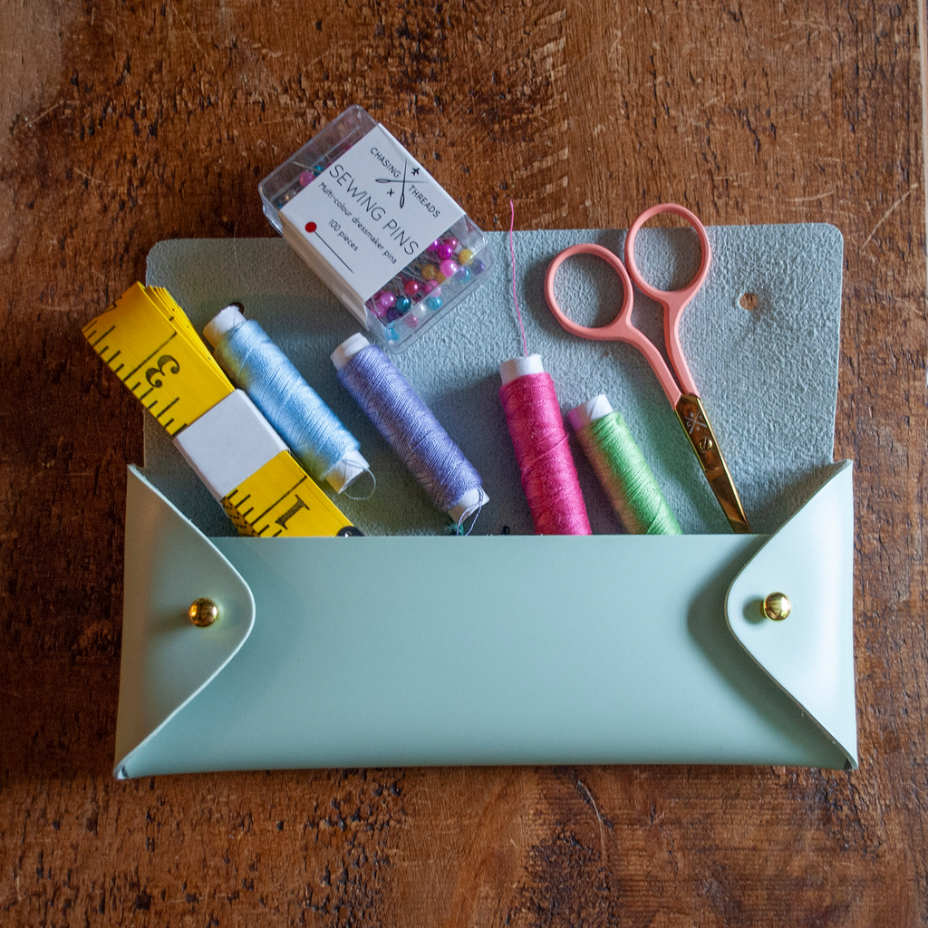 Stitch your own way - this envelope pocket is ideal as a pencil or glasses case and allows you to sew any unique design. Whether you stitch initials, a slogan or the sunglasses template included, it opens out fully for easy stitching. It also opens 2 ways, so it can open from the side or from the top - just pop the metal buttons to fold up whichever way you prefer. The Mint pouch comes with teal & navy thread &amp; needle wrapped on our pen thread-board. It includes our 3D alphabet template to add initial