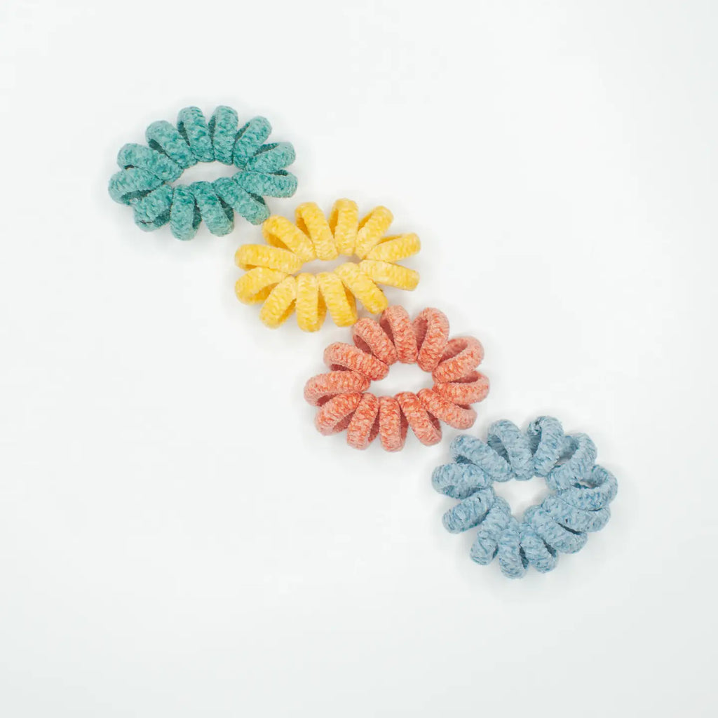 Have you seen our super cute Curly Cords? These knitted hair ties are a lifesaver for anyone who's tired of dealing with hair breakage from regular hair ties. You get four in a pack, with two different color combos. They're not only practical, but they add a bit of fun to any hairstyle. Trust me, you won't want to return to boring old hair ties once you've tried these out